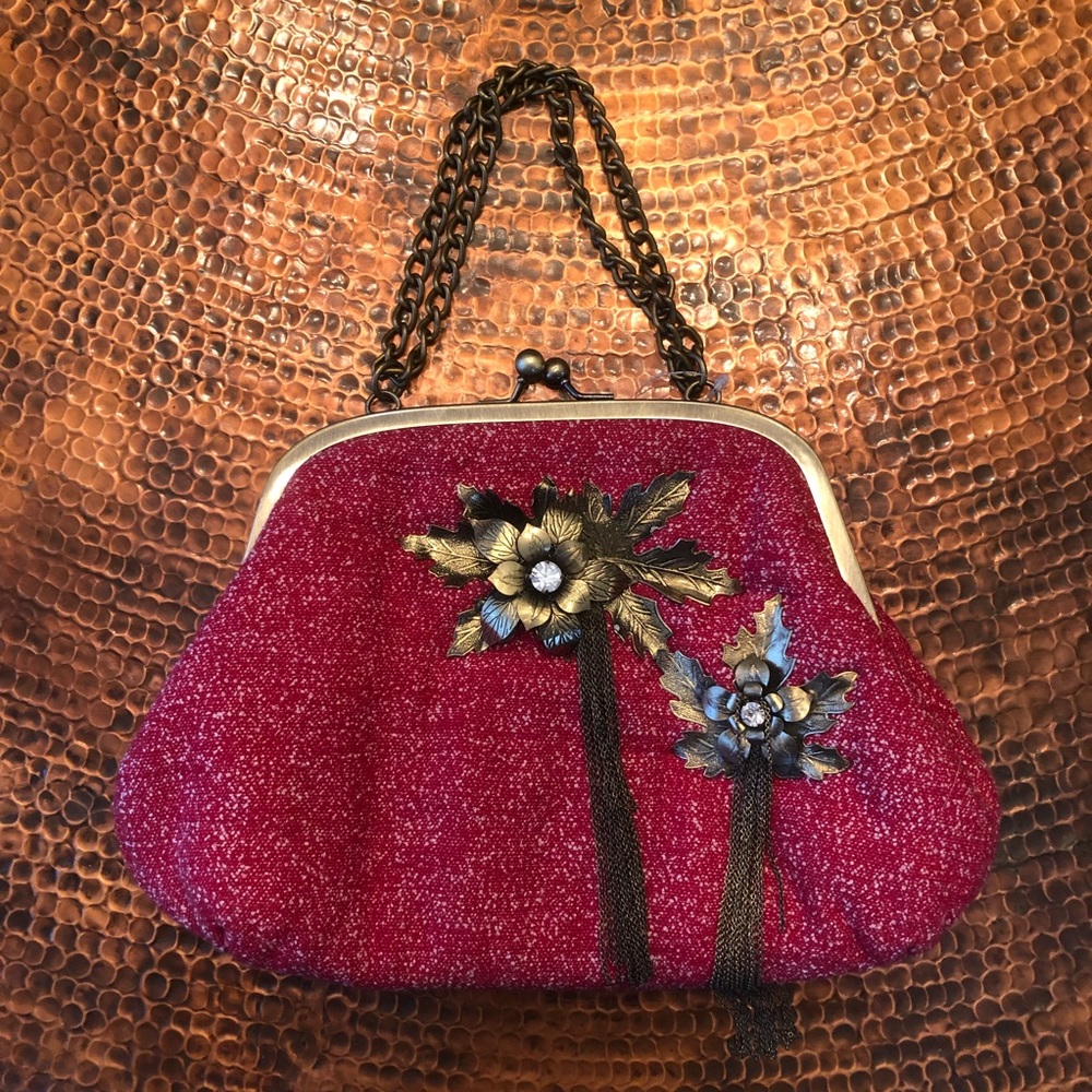 Red purse with bronze flowers